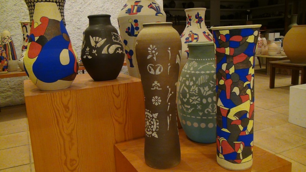 diversity of pieces, some with abstract pictorial representations of color, others white on dark background
